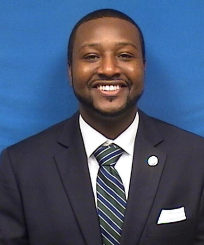 A person in a suit and tieDescription automatically generated with medium confidence